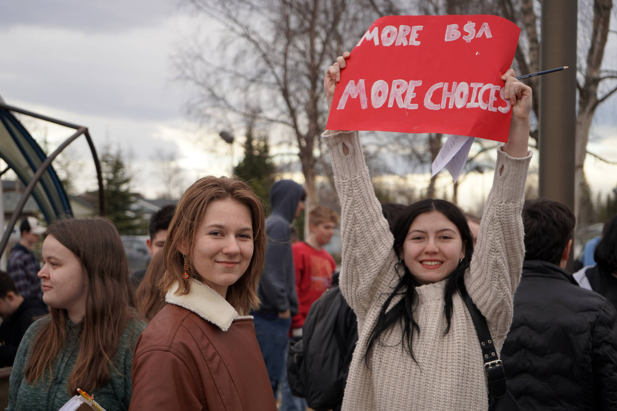 AJ Sorrell and Ariana Gonzales join other students of Soldotna High School as they stage a walkout in protest of the veto of Senate Bill 140 in front of their school in Soldotna, Alaska, on Wednesday, April 17, 2024. (Jake Dye/Peninsula Clarion)