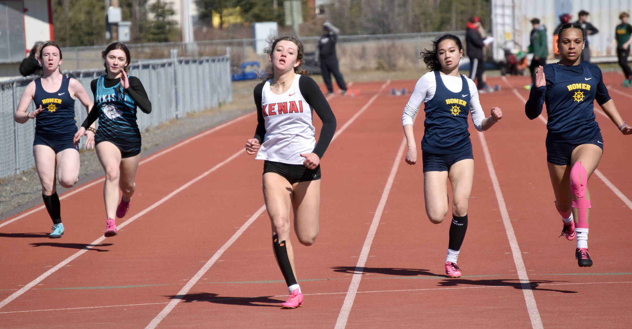 Kenai Central’s Sophie Tapley wins the 100 meters Saturday, April 27, 2024, at the Kenai Invitational at Kenai Central High School in Kenai, Alaska. (Photo by Jeff Helminiak/Peninsula Clarion)