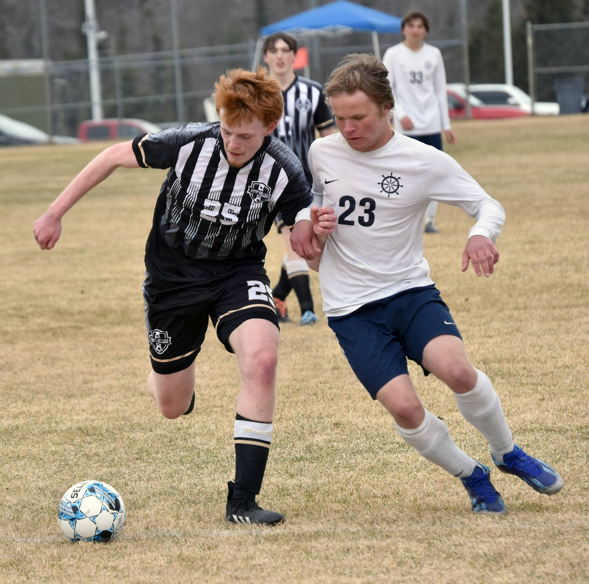 Nikiski’s Johnny Ralston dribbles against Homer’s Espen Hennick on Saturday, May 4, 2024, at Nikiski Middle-High School in Nikiski, Alaska. (Photo by Jeff Helminiak/Peninsula Clarion)