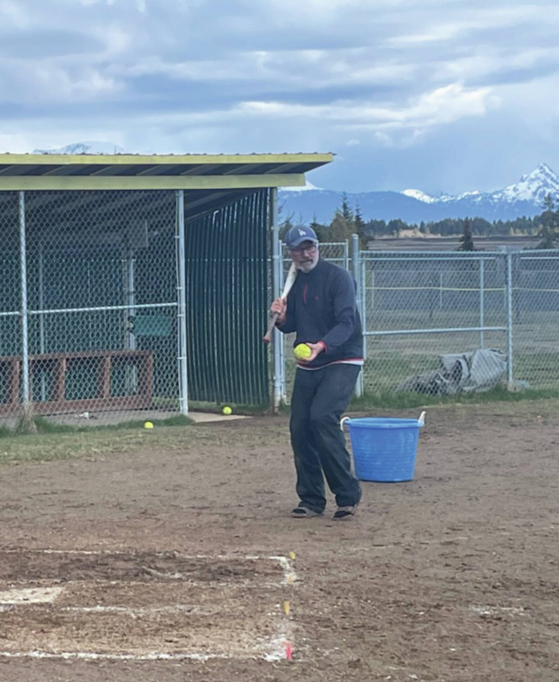 Coach Bill Bell pitching for Mariner softball at practice on Monday at Jack Gist Park in Homer. Emilie Springer/ Homer News.