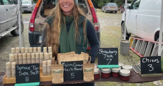 Opening day at the Homer Farmer’s Market on May 25, Megan Long with Wild Wellness Farm stands in front of her products. Emilie Springer/ Homer News.