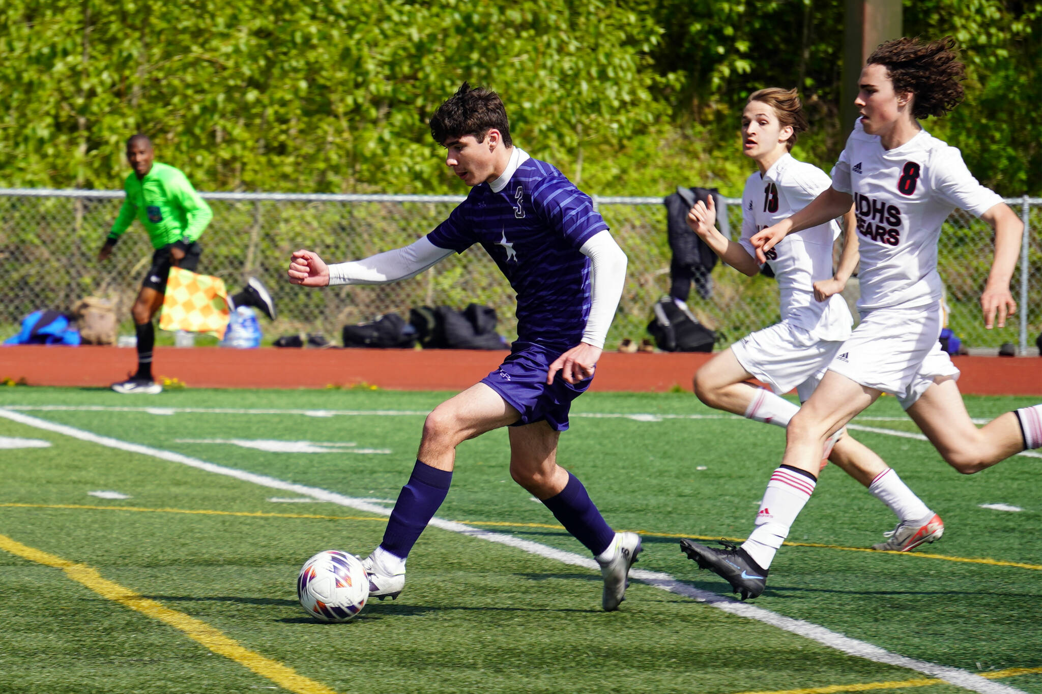 Soldotna’s Andrew Arthur outpaces Juneau-Douglas’ Xavier Melancon and Jesper Bennetsen on the way to a Stars goal during the ASAA Division II Soccer State Championships at Veterans Memorial Field in Wasilla, Alaska, on Saturday, May 25, 2024. (Jake Dye/Peninsula Clarion)