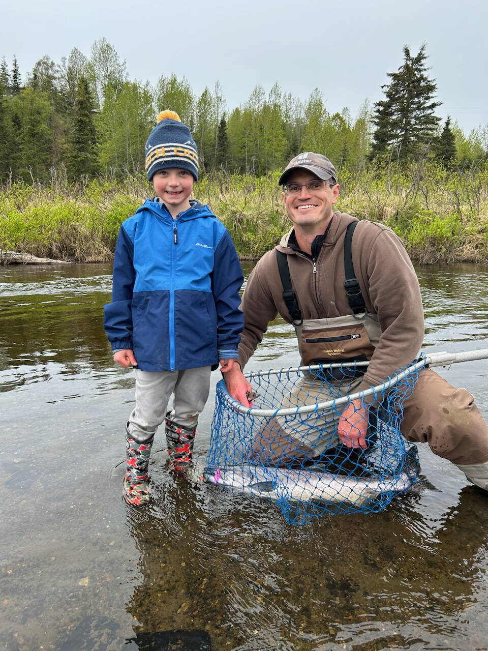 Thomas Hooker (left) poses with his dad, Garrett (right), and the king salmon he caught during the youth-only fishery held by the Alaska Department of Fish and Game on the Ninilchik River on Wednesday, June 5, 2024, in Ninilchik, Alaska. Photo provided by Mike Booz