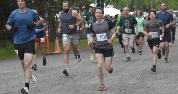 Lee Frey and Niko Zlotnik (501) lead the pack at the start of the 10-mile race at the Run for the River on Saturday, June 8, 2024, in Soldotna, Alaska. (Photo by Jeff Helminiak/Peninsula Clarion)