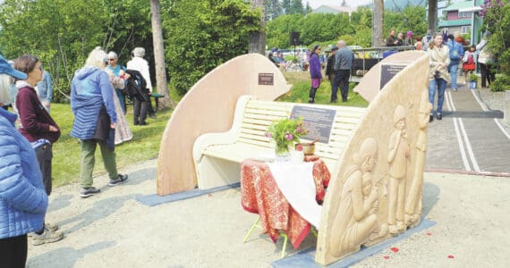 People visit at the Loved & Lost Memorial Bench on Sunday, June 12, 2022, at the Homer Public Library in Homer, Alaska, for a memorial for Anesha “Duffy” Murnane and the dedication of the bench. (Photo by Michael Armstrong/Homer News)