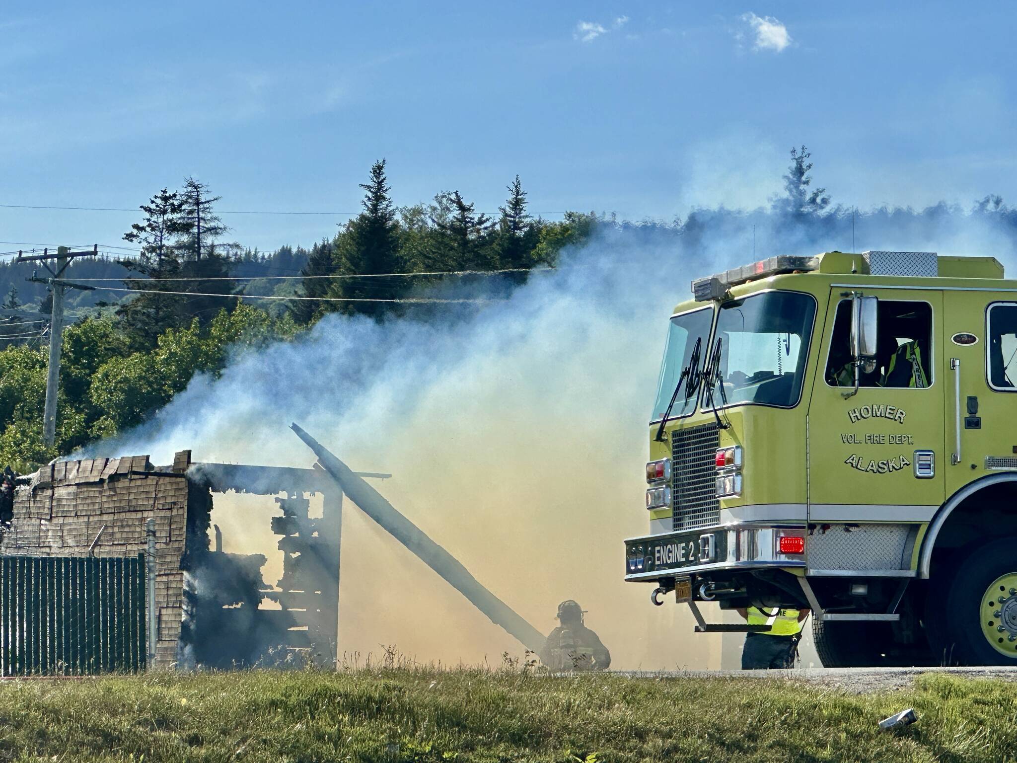 Homer Volunteer Fire Department works to extinguish an abandoned building on Lake Street on Friday, June 21, in Homer, Alaska. (Photo by Christina Whiting/courtesy)