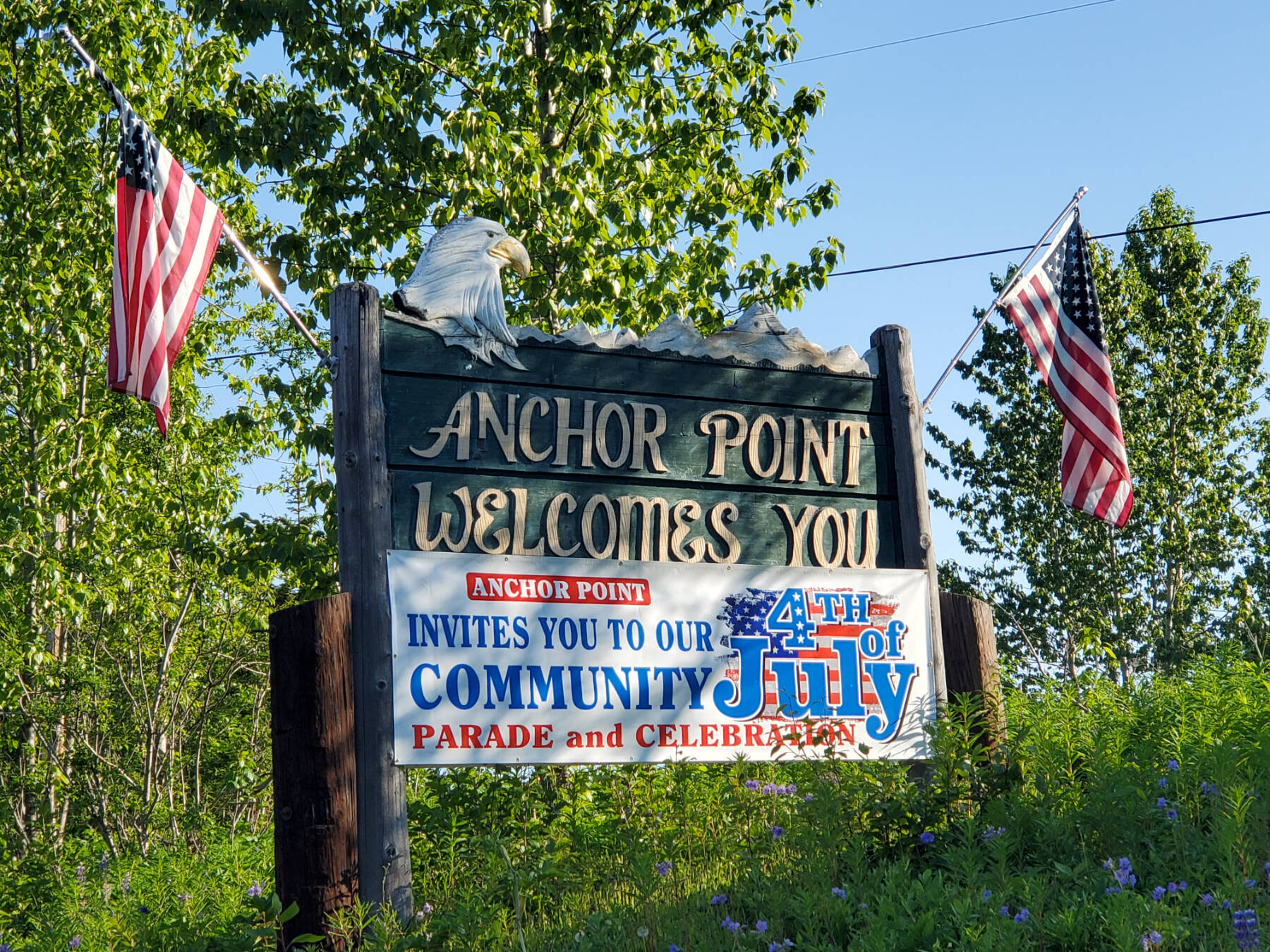 A banner on the northbound Anchor Point welcome sign, photographed on Saturday, June 22, 2024, advertises the upcoming annual Fourth of July celebrations hosted by VFW Post 10221 in Anchor Point, Alaska. (Delcenia Cosman/Homer News)