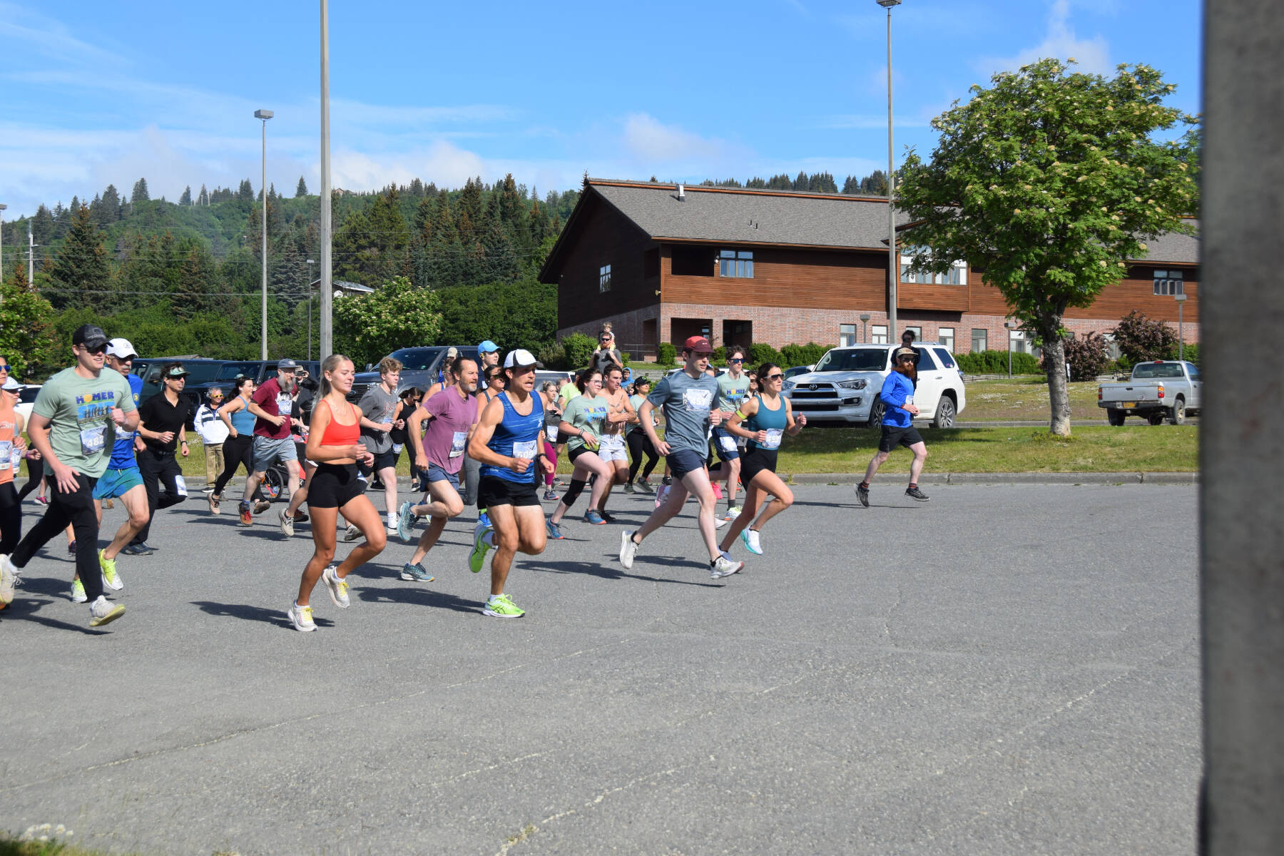 Runners in the Homer Spit Run 10K to the Bay take off from the starting line at Homer High School on Saturday, June 29, 2024, in Homer, Alaska. More than 160 runners and walkers participated in this year’s Spit Run overall, between the 10K to the Bay and the Cosmic Hamlet Half Marathon. (Delcenia Cosman/Homer News)