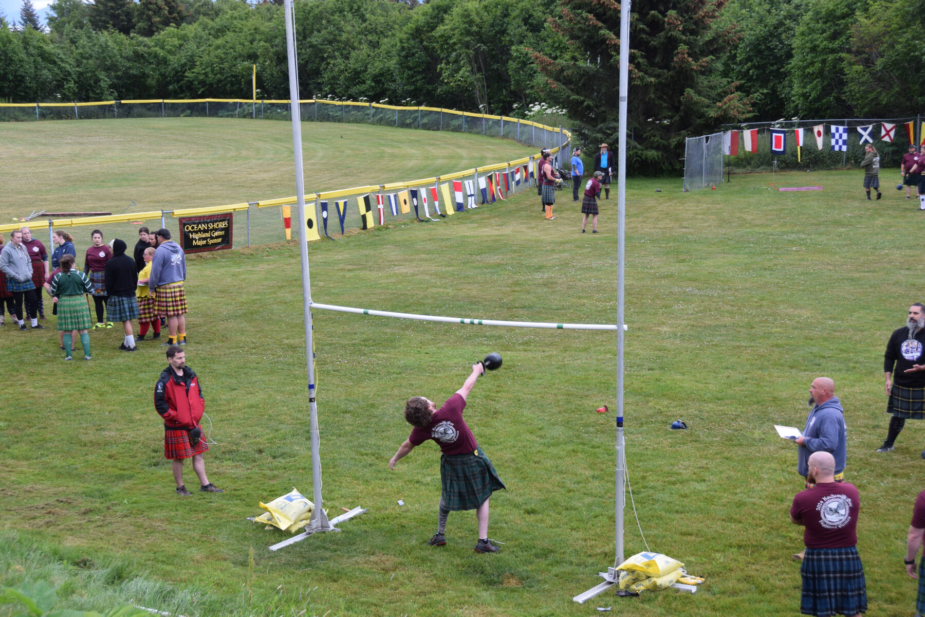 Ethan Smith (center) participates in the men’s open group for the weight-over-bar event during the 12th annual Kachemak Bay Scottish Highland Games on Saturday, July 6, 2024, at Karen Hornaday Park in Homer, Alaska. (Delcenia Cosman/Homer News)