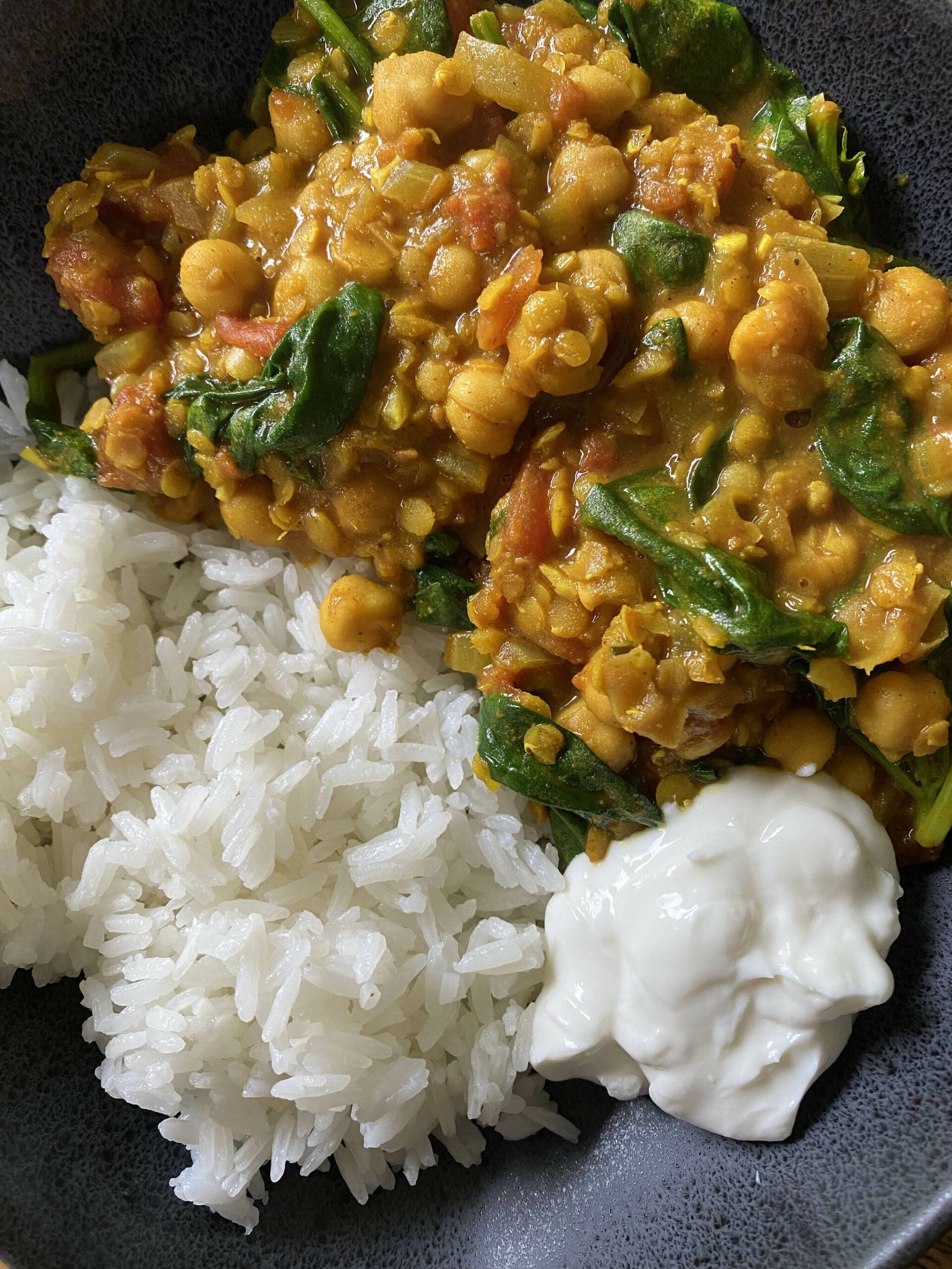 Chickpea lentil and spinach curry is served with rice and yogurt. (Photo by Tressa Dale/Peninsula Clarion)