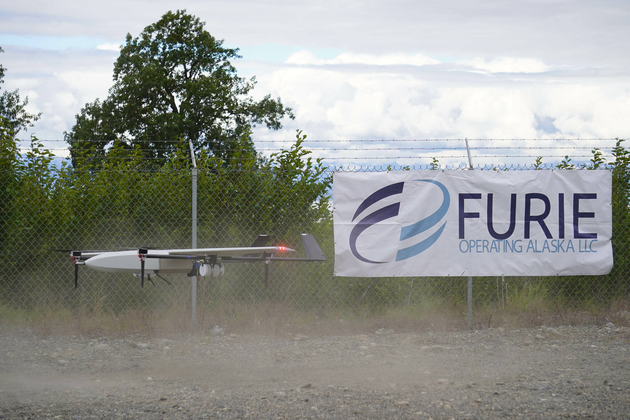 A drone lands while kicking up dust, returning from the test flight for the use of beyond visual line of sight drone aircraft, at Furie Operating Alaska’s central processing facility in Nikiski, Alaska, on Wednesday, July 10, 2024. (Jake Dye/Peninsula Clarion)