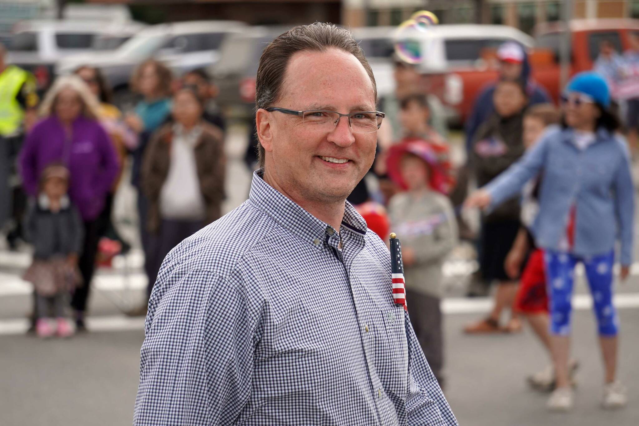 Rep. Ben Carpenter, R-Nikiski, walks down the Kenai Spur Highway in Kenai, Alaska, during the Fourth of July Parade on Thursday, July 4, 2024. (Jake Dye/Peninsula Clarion)