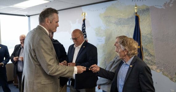 Gov. Mike Dunleavy hands out pens he used to sign the budget bills for the fiscal year that began July 1 to state lawmakers during a private ceremony in Anchorage on Thursday, June 27, 2024. (Official photo from The Office of the Governor)