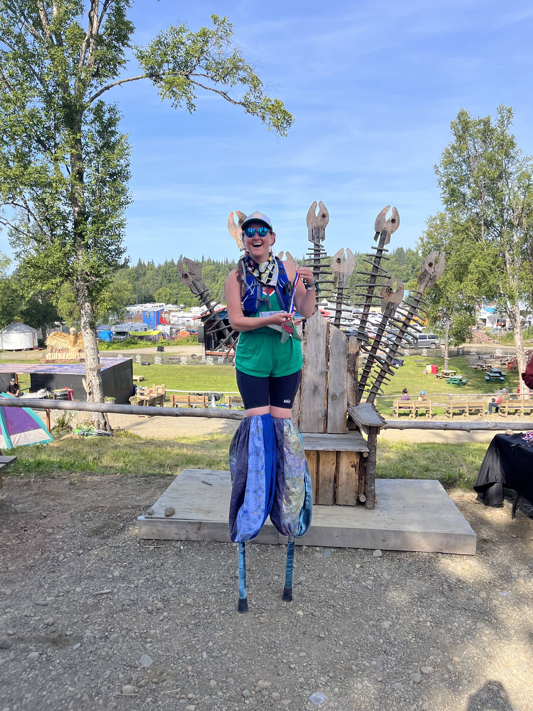 A participant on stilts poses by the Throne of Bones near the ARCHES campground in the Kenai Peninsula Fairgrounds following the second annual Great Salmon Run 5K on Saturday, Aug. 3, 2024, in Ninilchik, Alaska. Photo provided by Tiffany McCorison