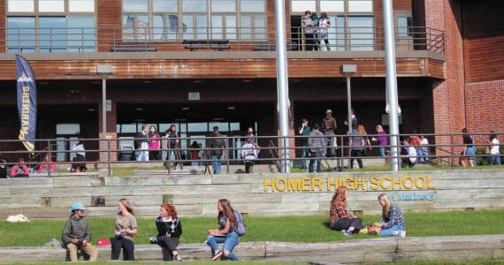 Homer High School students finish eating lunch outside the school while others make their way back into the building for the next class period on Monday, Aug. 24, 2020, in Homer, Alaska. (Photo by Megan Pacer/Homer News)