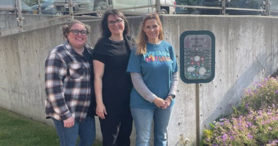 Morgan Laffert, volunteer coordinator, stands with two employees outside of the Homer Hospice building. (Emilie Springer/ Homer News.)