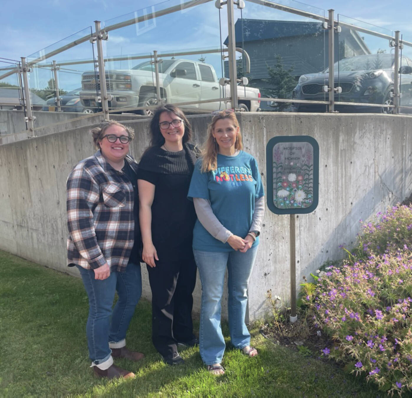 Morgan Laffert, volunteer coordinator, stands with two employees outside of the Homer Hospice building. (Emilie Springer/ Homer News.)