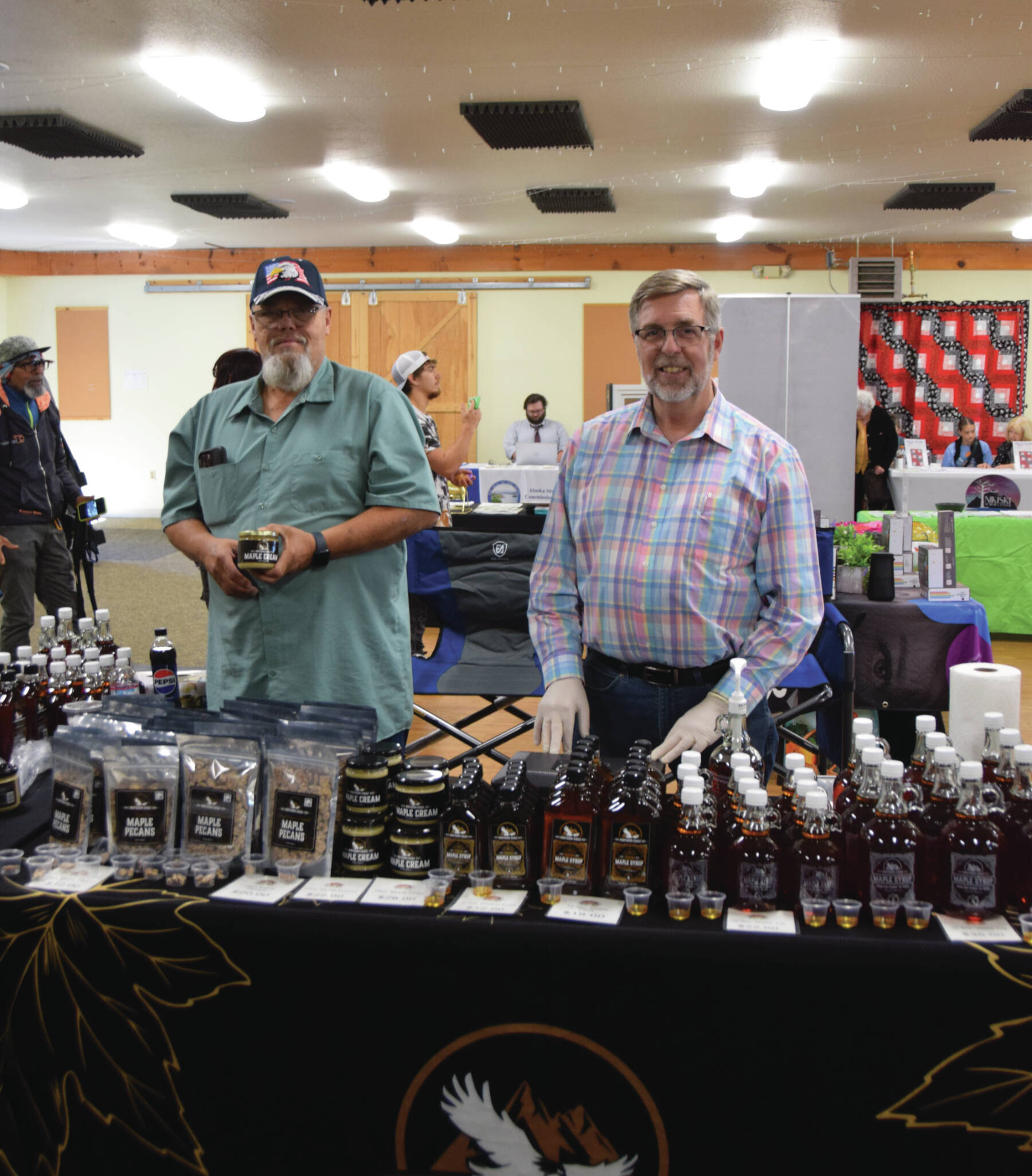 Emilie Springer/ Homer News
Representatives from Northern Eagle Market Maple pose in their booth in the opening hours of the Kenai Peninsula Fair on Aug. 9 in Ninilchik.