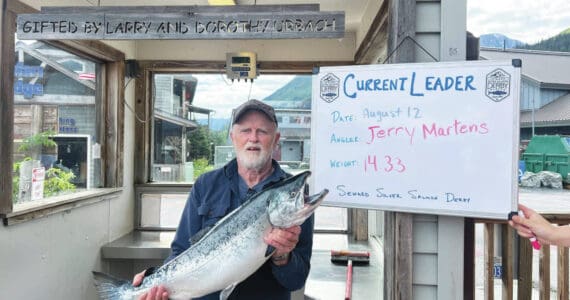 Photo provided by Seward Chamber of Commerce
Jerry Martens holds up a 14.33 pound silver salmon on Monday, Aug. 12, in Seward. As of Monday, that silver was the largest fish caught in the 69th Annual Seward Silver Salmon Derby and also outweighs last year’s winning catch.