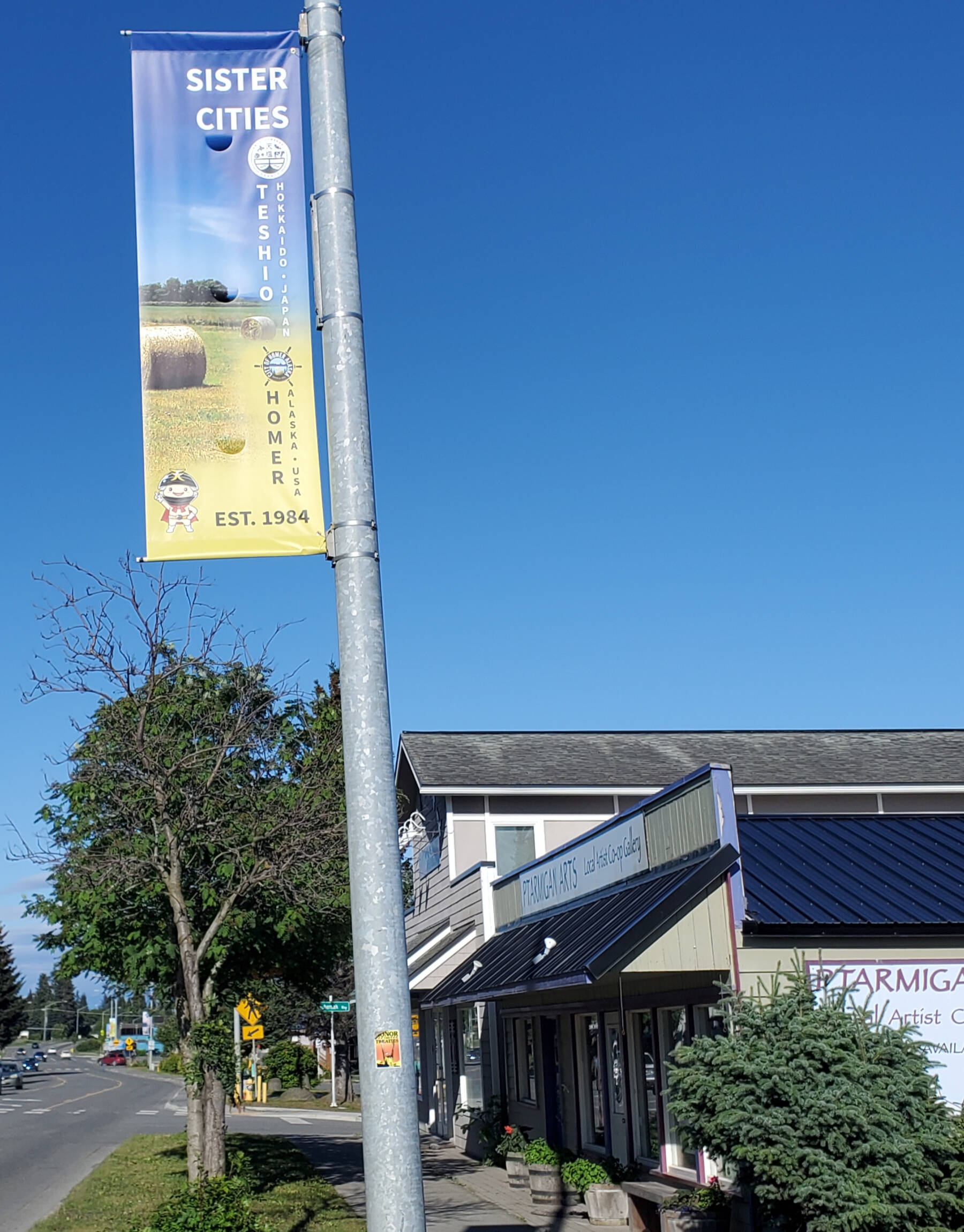 The new Homer / Teshio sister city banners are displayed on street lights along Pioneer Avenue on Friday, July 26, 2024, in Homer, Alaska. (Delcenia Cosman/Homer News)