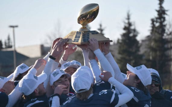 Soldotna hoists the First National Bowl on Saturday, Oct. 21, 2023, after the Division II championship game at Service High School in Anchorage, Alaska. (Photo by Jeff Helminiak/Peninsula Clarion)