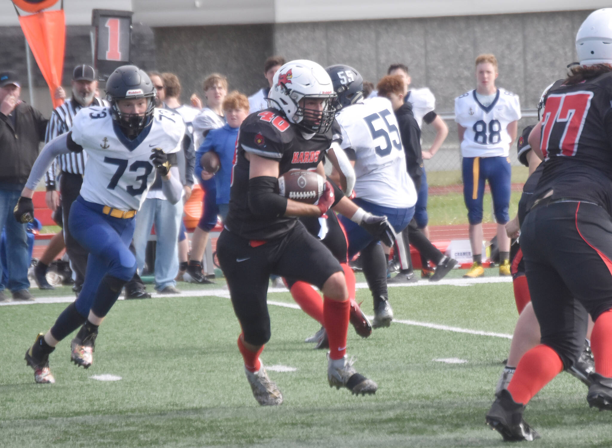 Kenai Central’s Bobby Hayes rushes the ball against Homer on Saturday, Aug. 17, 2024, at Ed Hollier Field at Kenai Central High School in Kenai, Alaska. (Photo by Jeff Helminiak/Peninsula Clarion)