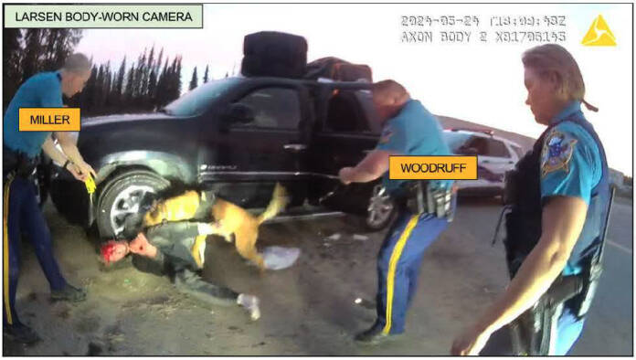 Troopers Joseph Miller Jr. and Jason Woodruff are seen as K9 Olex bites Ben Tikka in a screenshot from body camera footage taken in Kenai, Alaska, on May 24, 2024. (Photo provided by Alaska Department of Law)