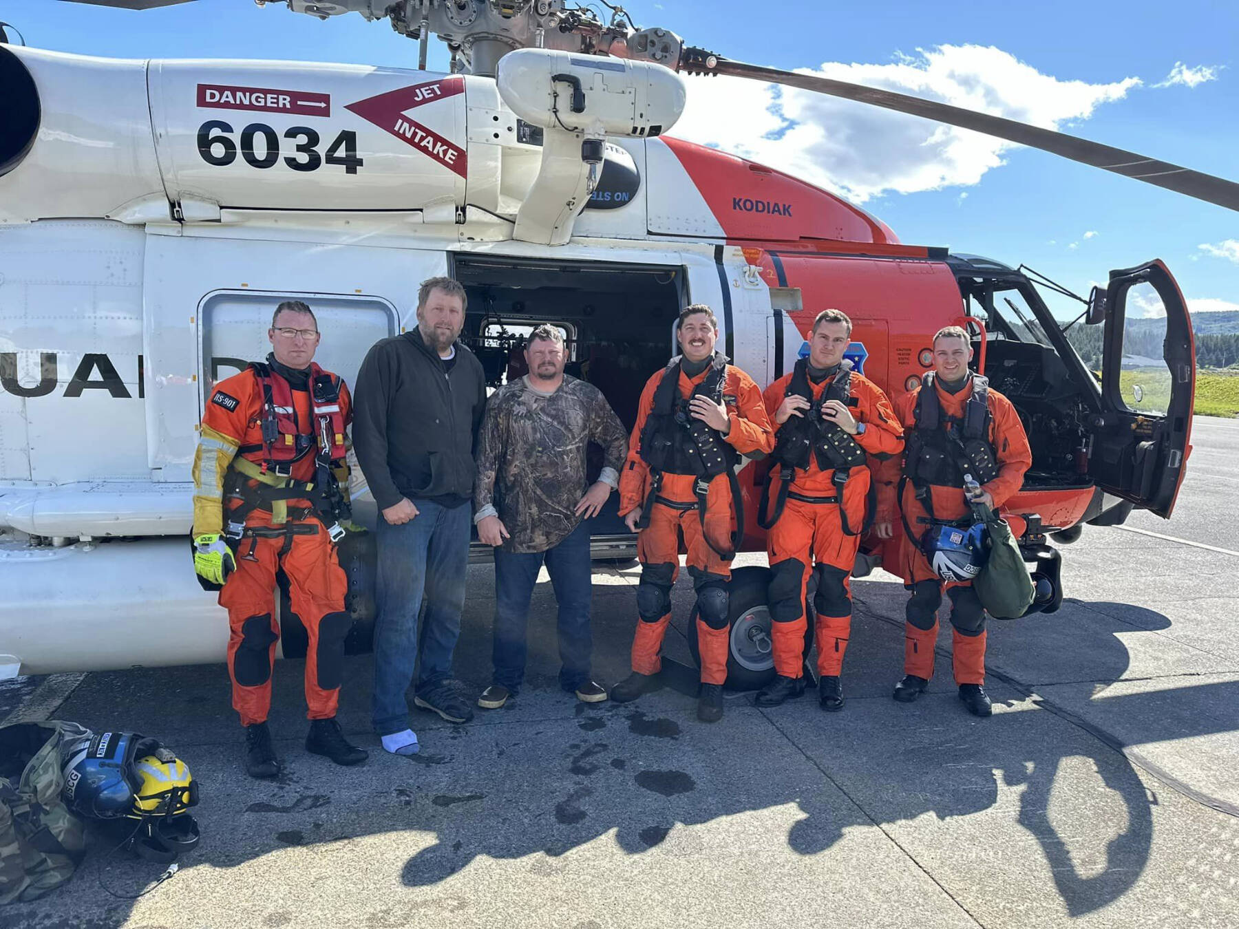 Richard Gregoire (center left) and Darrell Card (center right) were rescued by the U.S. Coast Guard Air Station Kodiak 62 miles off the Kodiak coast on Monday, Aug. 12, 2024, when they were stranded in their skiff after their boat sank. Also pictured are the crew of the MH-60 Jayhawk, including Lt. Cmdr. David Carrier, Lt. Joseph Sayre, Aviation Maintenance Technician Petty Officer 2nd Class Eric Baker and Aviation Survival Technician Petty Officer 2nd Class Russell Grizzard. Photo courtesy of the U.S. Coast Guard