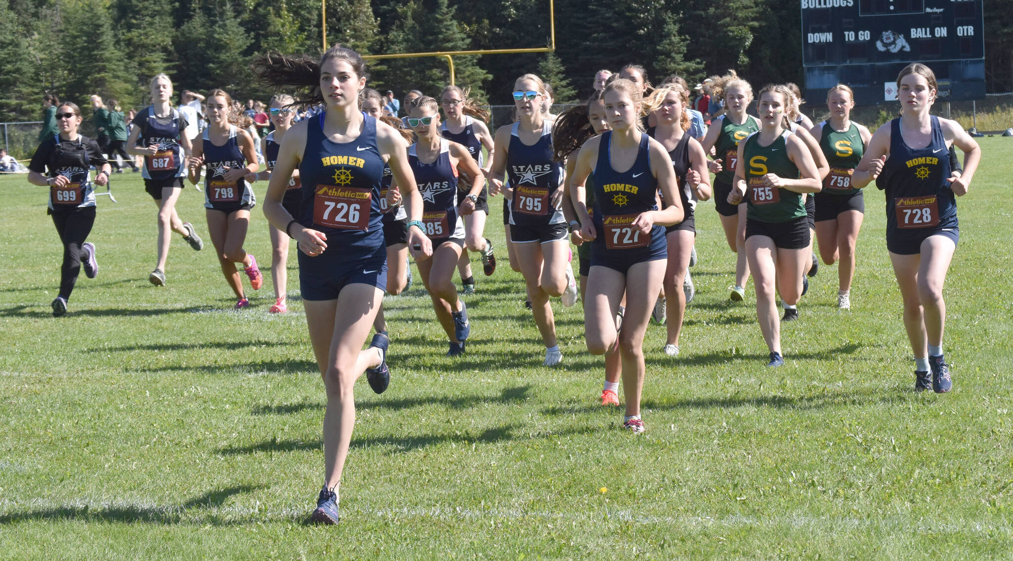 Homer’s Etta Bynagle leads the pack at the start of the freshmen-sophomore girls race Monday, Aug. 19, 2024, at Nikiski Middle-High School at the Peninsula Class Races in Nikiski, Alaska. (Photo by Jeff Helminiak/Peninsula Clarion)