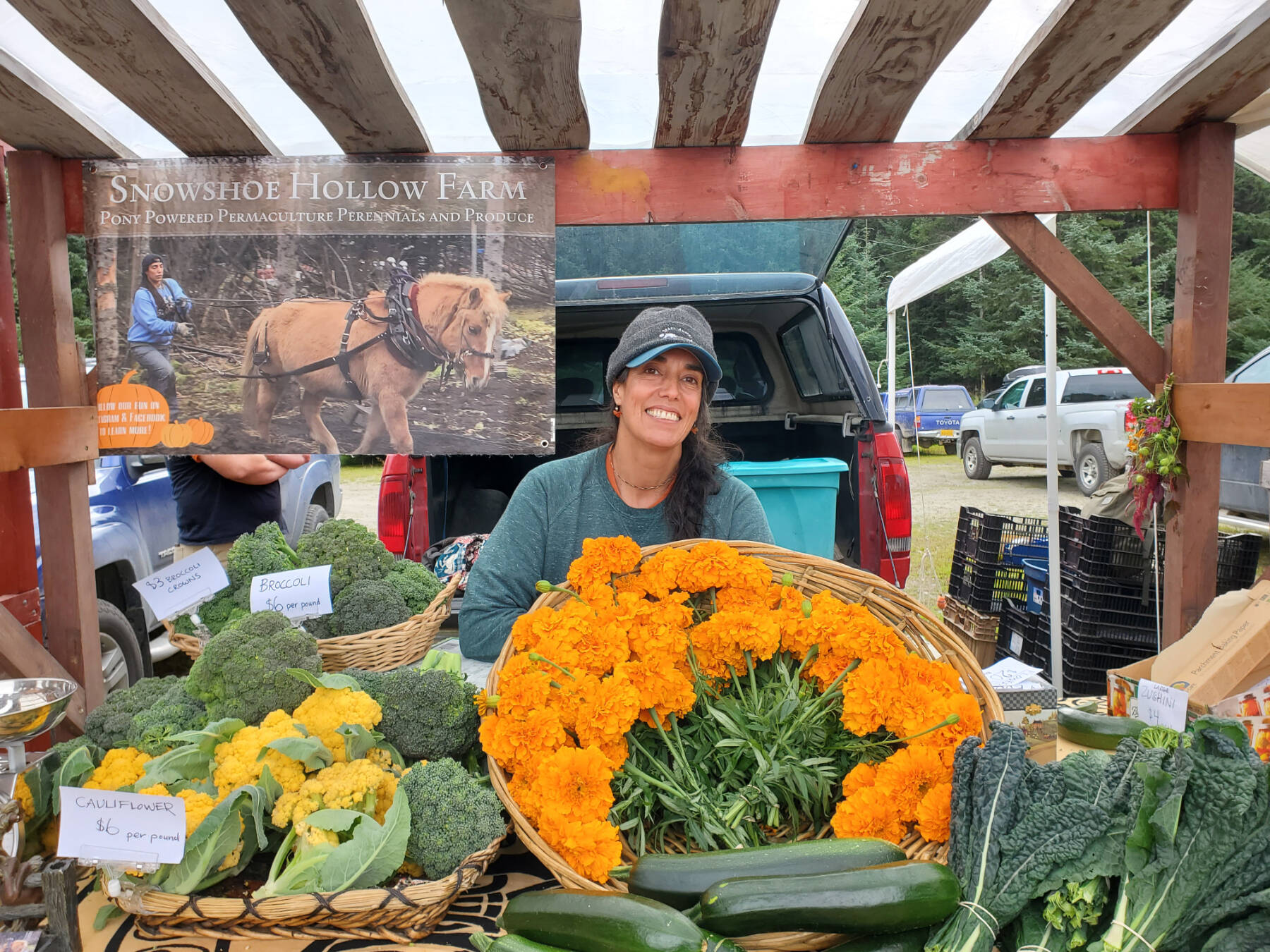 Christina Castellanos, owner and operator of Snowshoe Hollow Farm, is named the new Zucchini Queenie during the Zucchini Festival at the Homer Farmers Market on Saturday, Aug. 24, 2024, in Homer, Alaska. (Delcenia Cosman/Homer News)