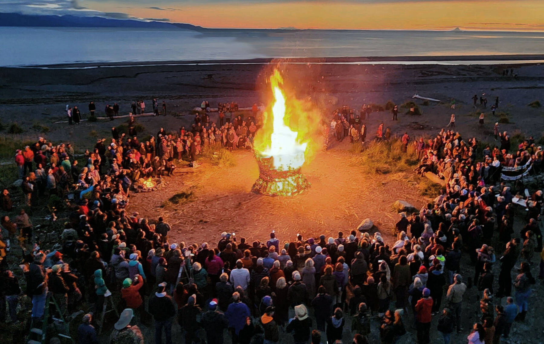 Community members gather around the ignited 2023 Burning Basket, titled “Create,” on Sept 10, 2023 at Mariner Park in Homer, Alaska. Photo provided by Mavis Muller