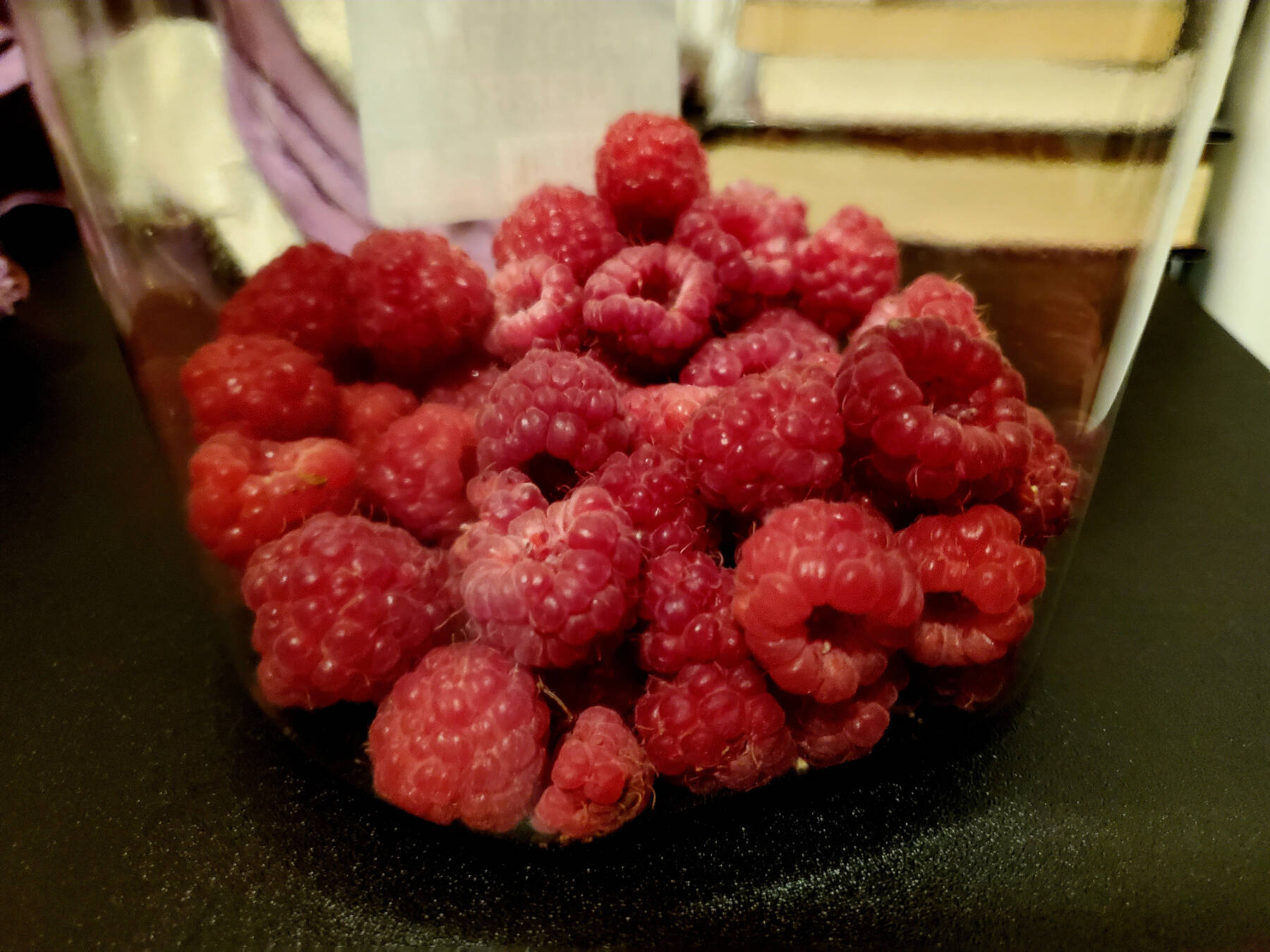 Raspberries fill a bucket on Saturday, Aug. 17, 2024, in Homer, Alaska. (Delcenia Cosman/Homer News)