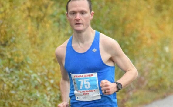 Kenai's Jason Parks, running on Kalifornsky Beach Road in Kenai, Alaska, wins the Kenai River Marathon on Sept. 28, 2019. (Photo by Jeff Helminiak/Peninsula Clarion)