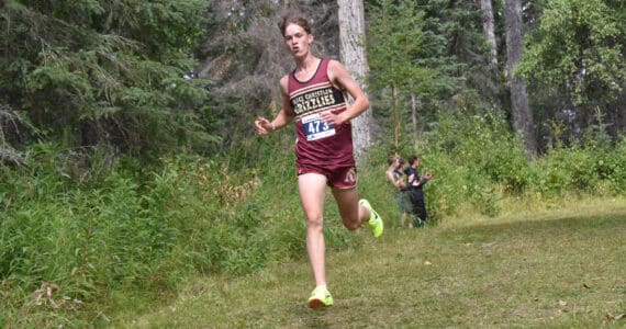 Grace Christian’s Robbie Annett leads the boys varsity race at the Ted McKenney XC Invitational on Saturday, Aug. 24, 2024, at Tsalteshi Trails just outside of Soldotna, Alaska. (Photo by Jeff Helminiak/Peninsula Clarion)