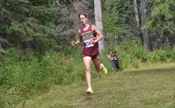 Grace Christian’s Robbie Annett leads the boys varsity race at the Ted McKenney XC Invitational on Saturday, Aug. 24, 2024, at Tsalteshi Trails just outside of Soldotna, Alaska. (Photo by Jeff Helminiak/Peninsula Clarion)