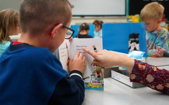 Students sit down to read books on the first day of the school year at Tustumena Elementary School in Kasilof, Alaska, on Wednesday, Aug. 21, 2024. (Jake Dye/Peninsula Clarion)