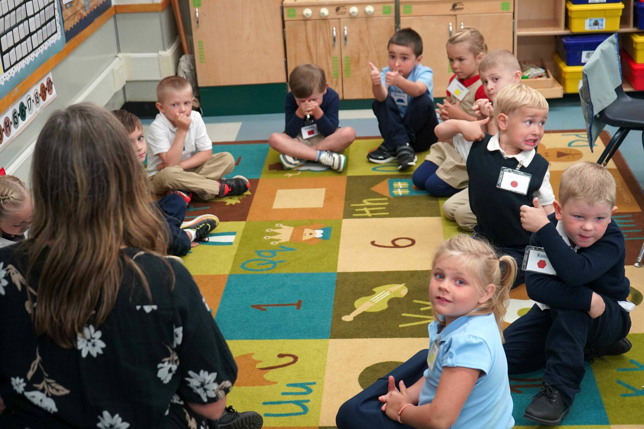 Kindergarteners give “thumbs up” to their teacher at Aurora Borealis Charter School in Kenai, Alaska, on the first day of the school year Wednesday, Aug. 21, 2024. (Jake Dye/Peninsula Clarion)