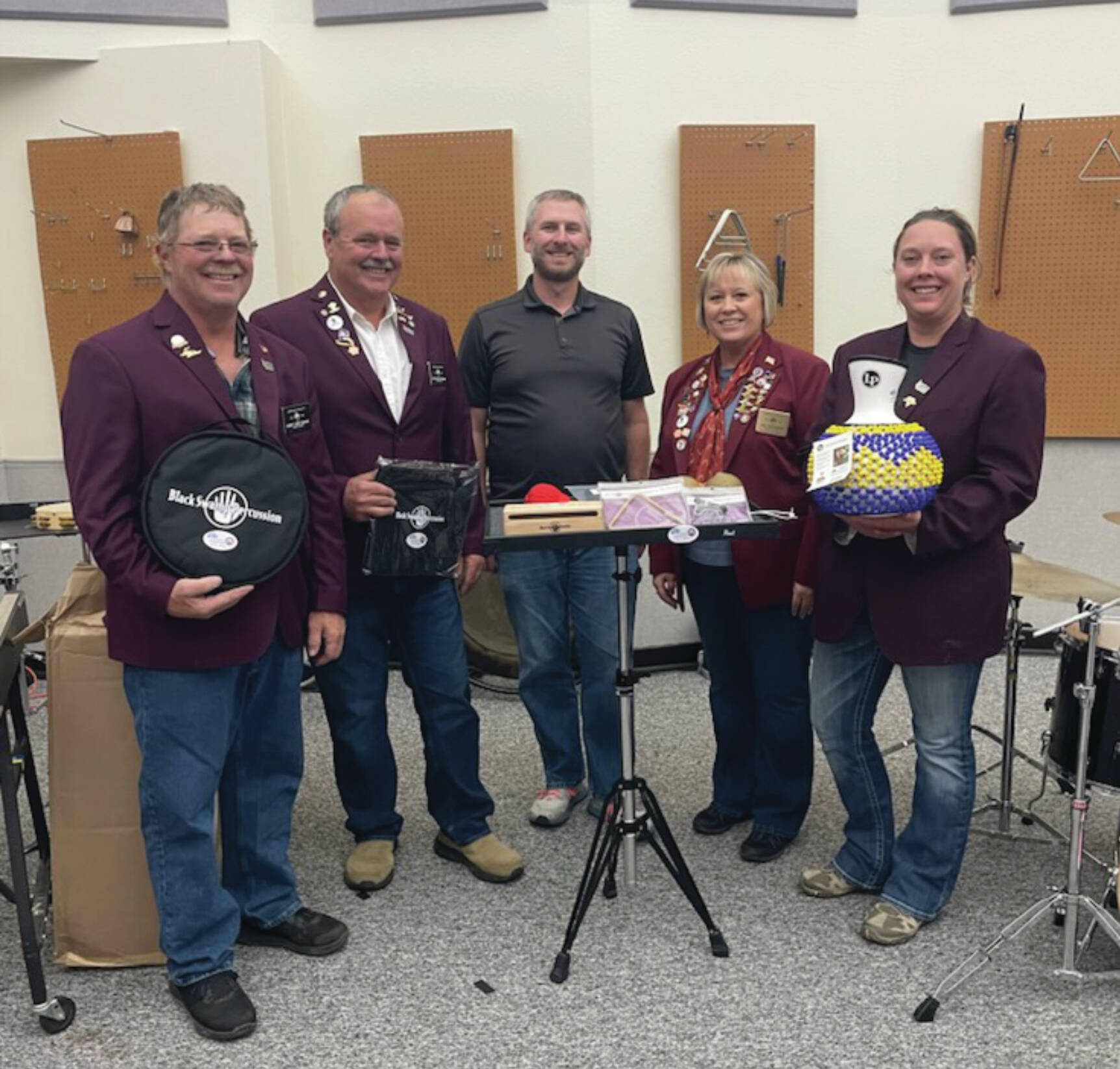 Left to right: Elks member Robert “Lenny” Euberts, Matthew Hockema, Homer High School band instructor Eric Simondsen, Lodge Exalted Ruler Jill Hockema and Heather Turner present instruments donated by Homer Elks Lodge #2127 to Homer High School on Friday, Aug. 30. (Emilie Springer/Homer News)