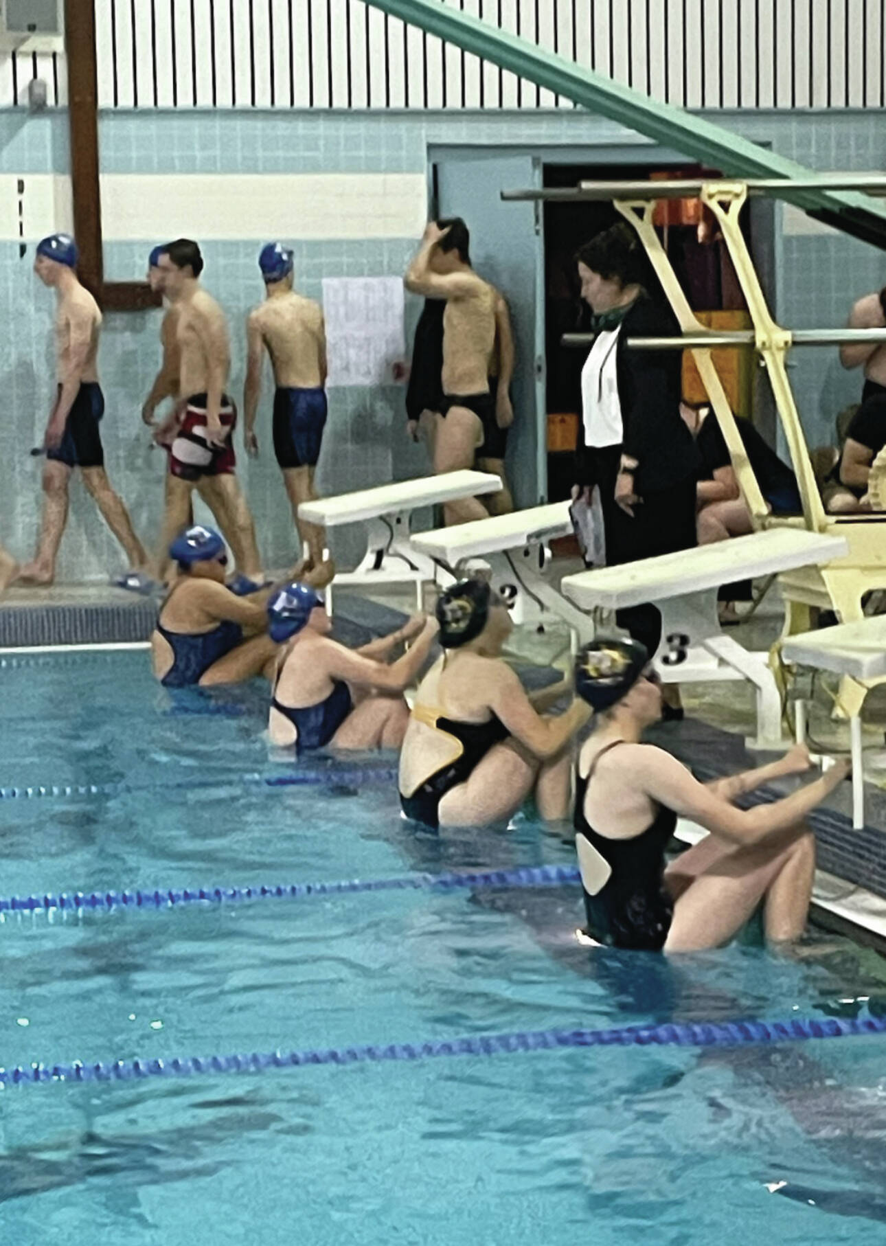 Mariner swim team members Cassidy Carroll and Avery Briscoe prepare for the 100-yard backstroke at the Mariner pool on Sept. 7, 2024, in Homer, Alaska. (Photo by Emilie Springer/Homer News)