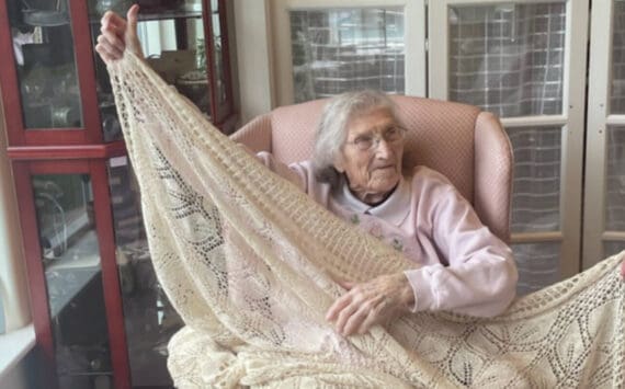 Dorris James, who will turn 100 on Sept. 28, 2024, displays a crocheted tablecloth that she made several decades ago. The photo was taken on Sept. 11, 2024, at her daughter’s home in Homer, Alaska. (Emilie Springer/ Homer News)