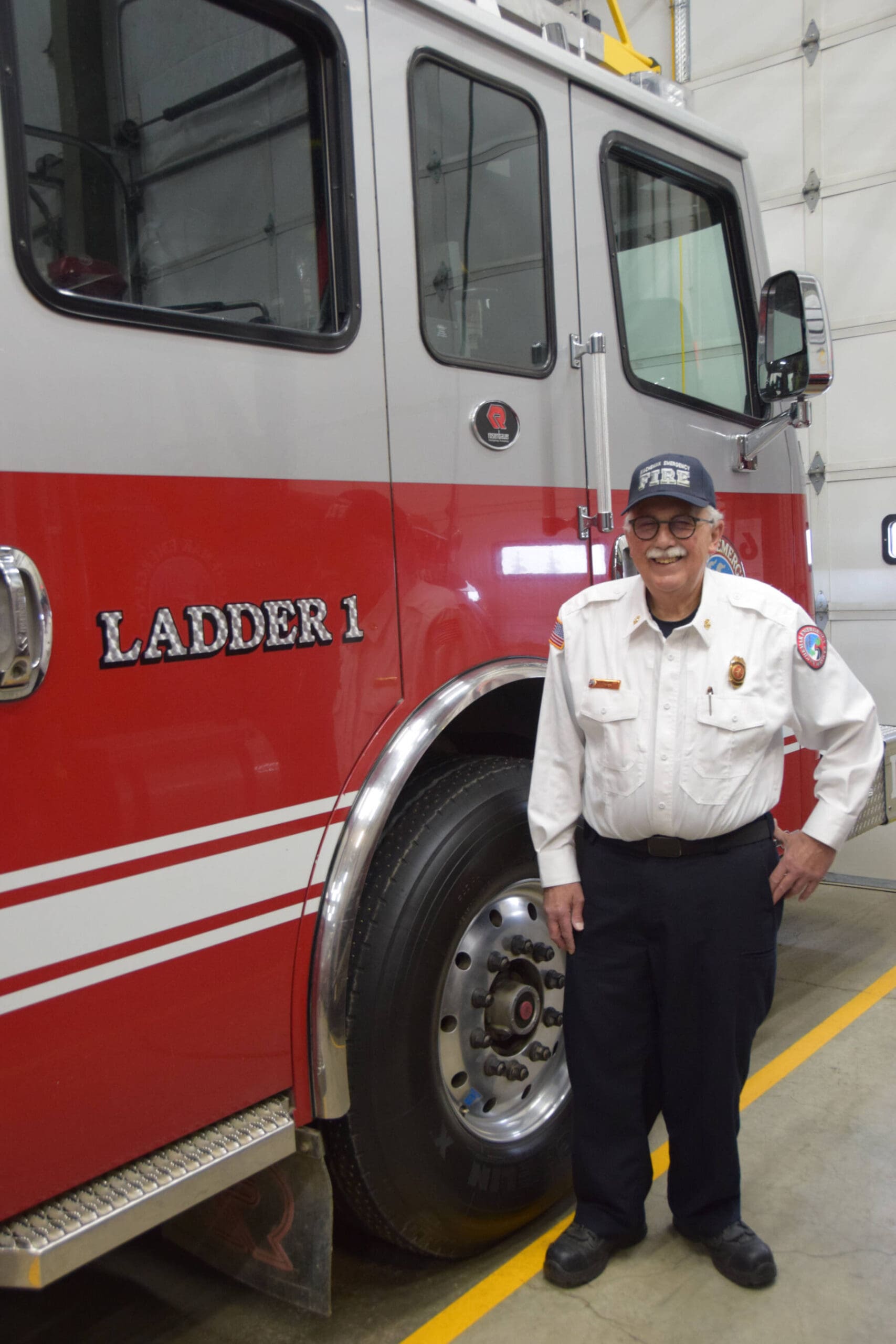 Retired fire chief Robert Cicciarella stands next to the Kachemak Emergency Services Ladder 1 truck on Thursday, Sept. 12, 2024, at KESA Station 1 in Homer, Alaska. (Delcenia Cosman/Homer News)