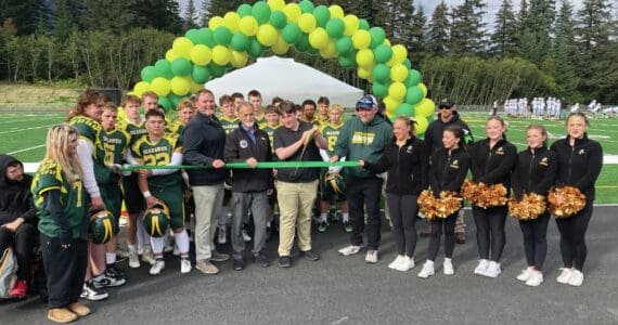 Center, from left: Kenai Peninsula Borough School District Superintendent Clayton Holland; Borough Mayor Peter Micciche; Seward High Student Council President Otto Nipp; and Seward High School Principal Dr. Henry Burns participate in a ribbon-cutting ceremony for a new turf field at Roger Steinbrecher Memorial Field at Seward High School, Friday, Sept. 13, 2024, in Seward, Alaska. (Photo by Jeff Helminiak/Peninsula Clarion)