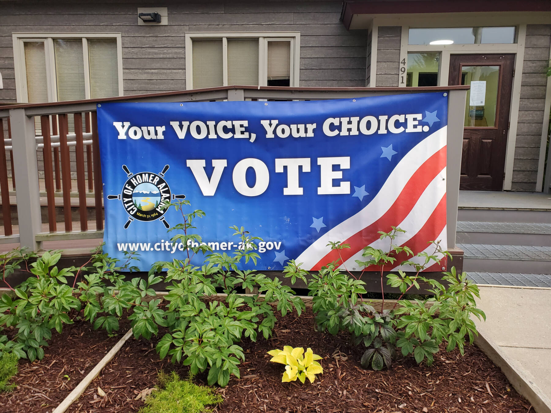 A banner encouraging Homer residents to vote is displayed outside City Hall on Thursday, Sept. 12, 2024 in Homer, Alaska. (Delcenia Cosman/Homer News)