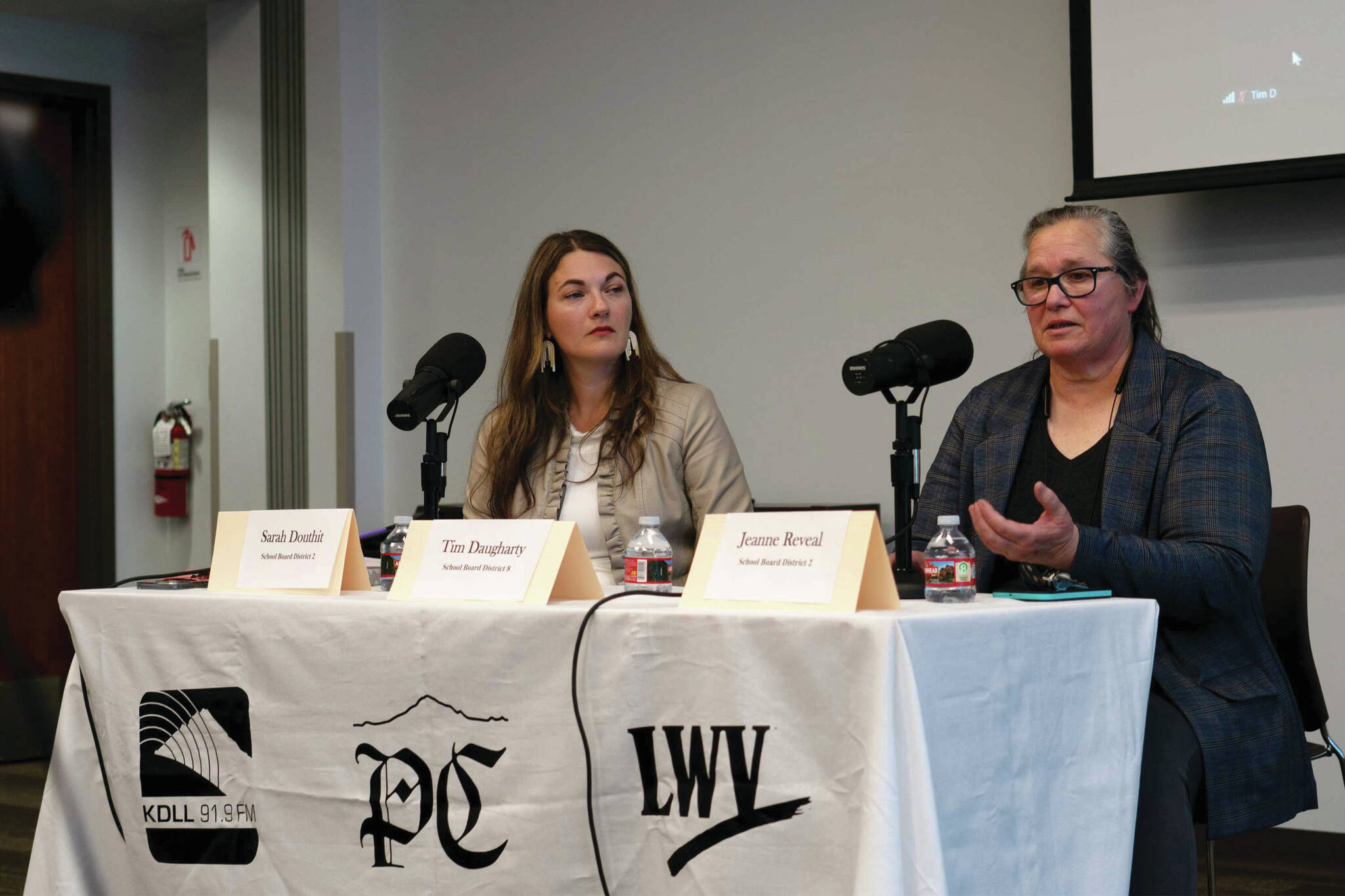 Sarah Douthit and Jeanne Reveal participate in a candidate forum for the Kenai Peninsula Borough School District Board of Education at the Soldotna Public Library in Soldotna on Monday. (Jamie Diep/KBBI)