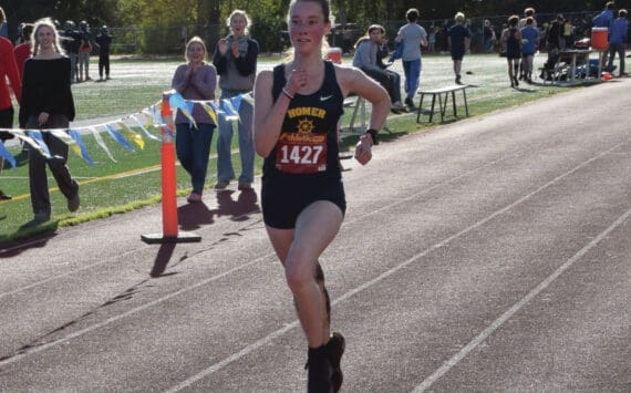 Photo by Emilie Springer/Homer News
Senior varsity runner Bea McDonough approaches the finish line to take second place in the Kenai Peninsula Borough cross country championships in Homer<ins>, Alaska</ins> on Thursday, Sept. 19<ins>,</ins> <ins>2024</ins>.