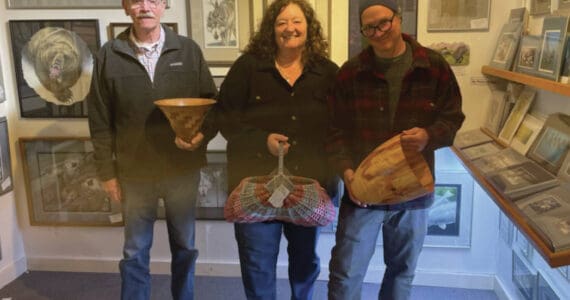 Emilie Springer/Homer News
Current Ptarmigan Arts cooperative members Ted Heuer, Susan Stuart and George Overpeck pose with their work next to longtime member Gary Lyon’s paintings on Friday, Sept. 20<ins>, 2024,</ins> at the gallery on Pioneer Avenue<ins> in Homer, Alaska</ins>.