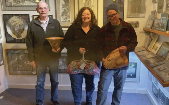 Emilie Springer/Homer News
Current Ptarmigan Arts cooperative members Ted Heuer, Susan Stuart and George Overpeck pose with their work next to longtime member Gary Lyon’s paintings on Friday, Sept. 20<ins>, 2024,</ins> at the gallery on Pioneer Avenue<ins> in Homer, Alaska</ins>.