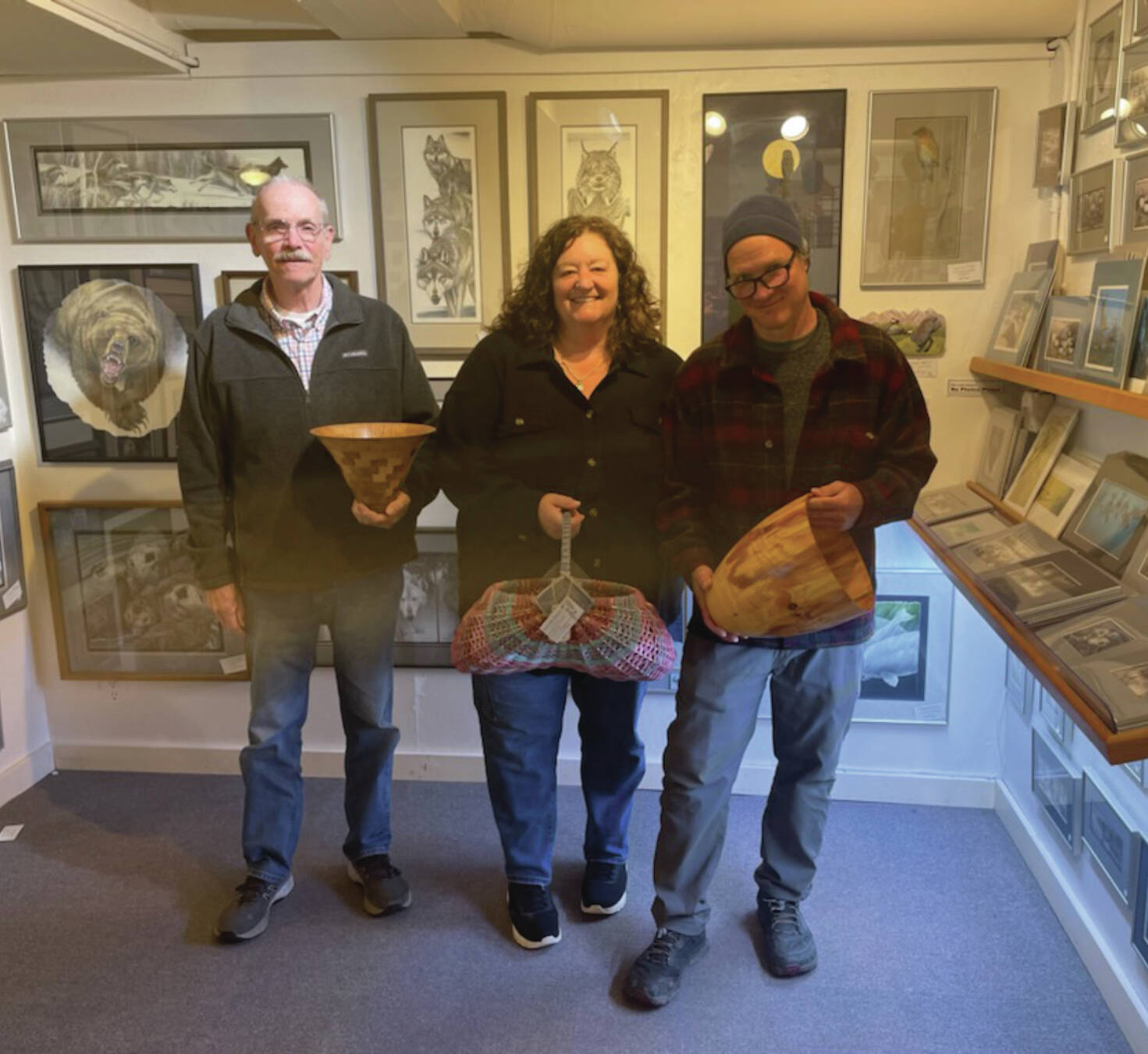 Emilie Springer/Homer News
Current Ptarmigan Arts cooperative members Ted Heuer, Susan Stuart and George Overpeck pose with their work next to longtime member Gary Lyon’s paintings on Friday, Sept. 20<ins>, 2024,</ins> at the gallery on Pioneer Avenue<ins> in Homer, Alaska</ins>.