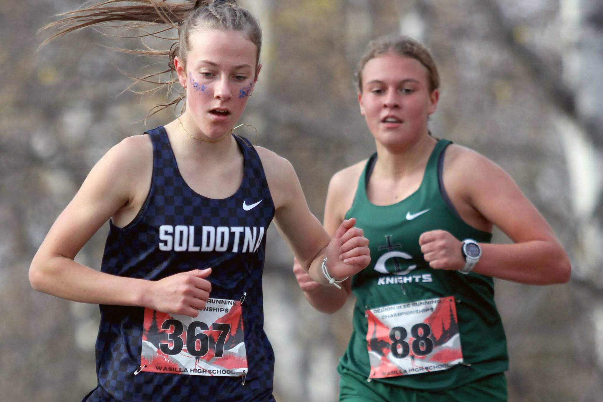 Soldotna's Tania Boonstra runs just ahead of Colony's Aubrey Virgin during the Division I varsity girls race of the Region 3 Championships on Saturday, Sept. 28, 2024, in Wasilla, Alaska. (Photo by Jeremiah Bartz/Frontiersman)