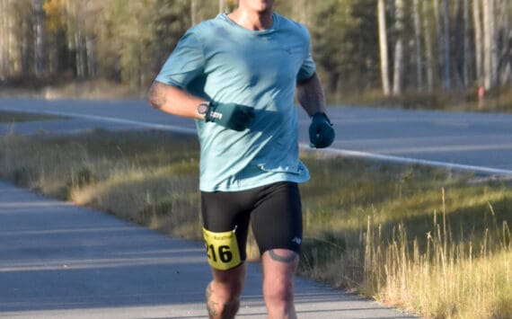 Anchorage’s Micah Templin runs to victory in the men’s half marathon at the Kenai River Marathon on Sunday, Sept. 29, 2024, in Kenai, Alaska. (Photo by Jeff Helminiak/Peninsula Clarion)